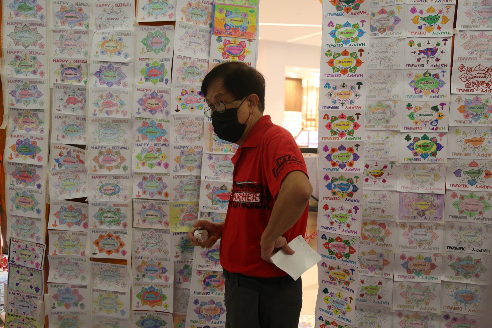 The official record keeper from the SBOR counted cards hanging from floor to ceiling and spread out of the ground the Tekka Place shopping mall. Photo Courtesy: SingaRangoli 