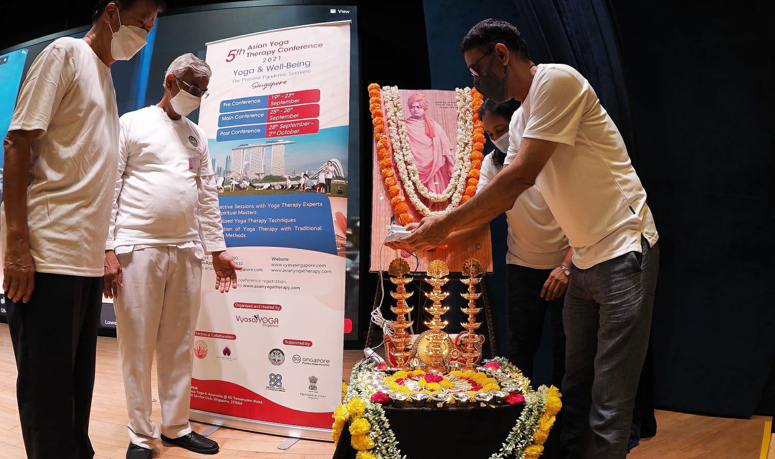 The main conference started with the welcome address by Manoj Thakur, Managing Director, Vyasa Yoga Singapore, followed by the lamp-lighting ceremony by Charlie Ng, General Manager, Civil Service Club, Singapore (left) and HE P. Kumaran, High Commissioner of India to Singapore (centre). Photo courtesy: AYTA
