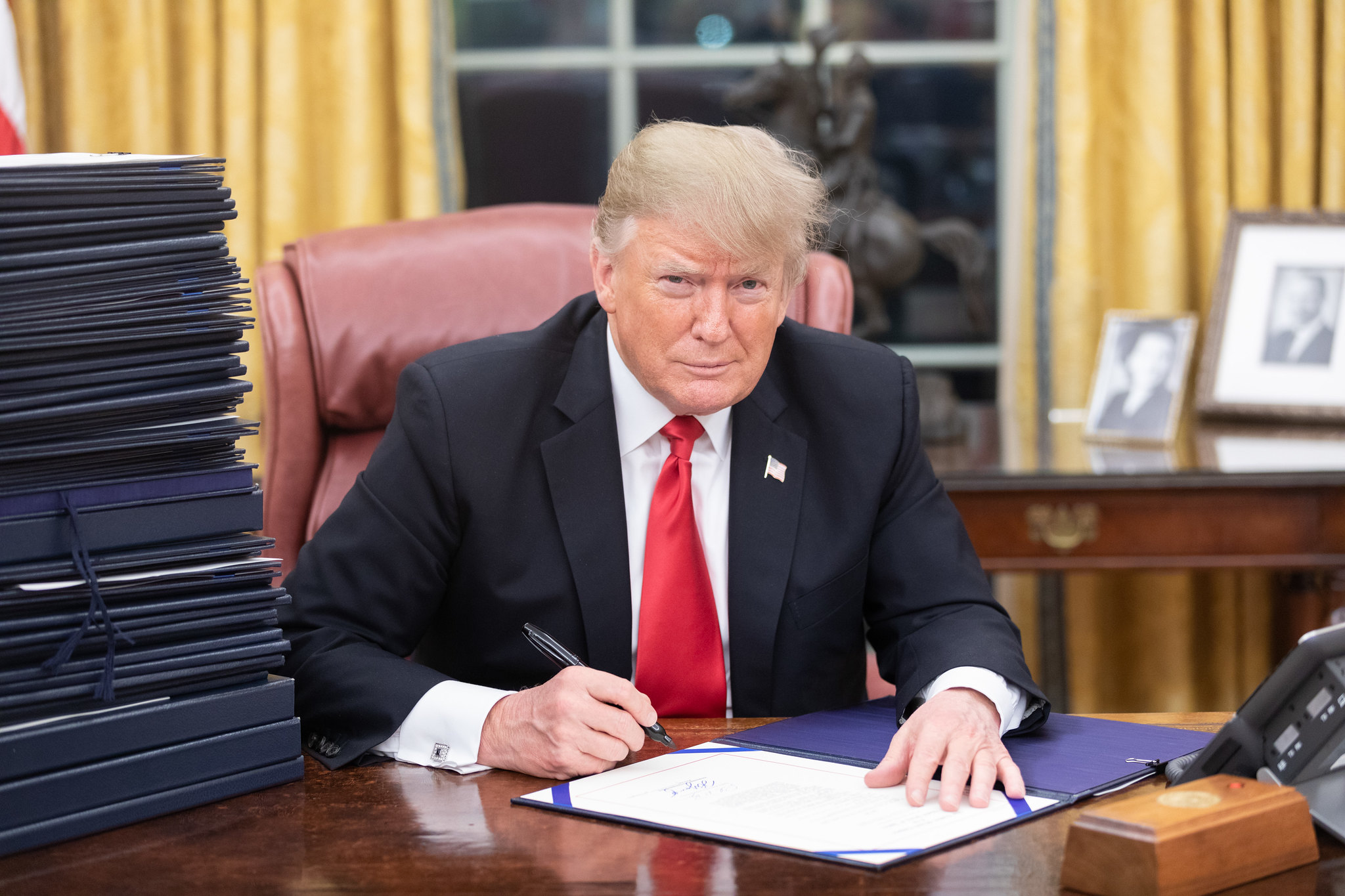President Donald J. Trump is seen at his desk Friday evening, December 21, 2018, in the Oval Office