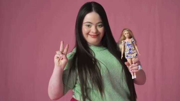 Diversity Barbie with Down Syndrome gets a big hug from teenage British model