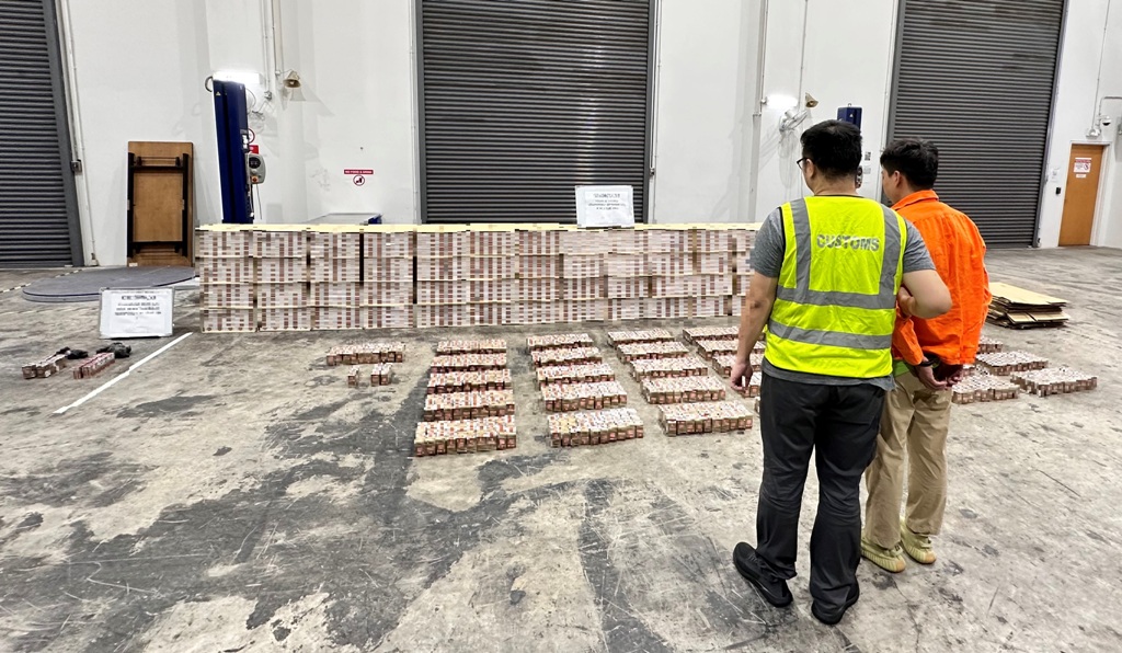 Singapore Customs officer with arrested man