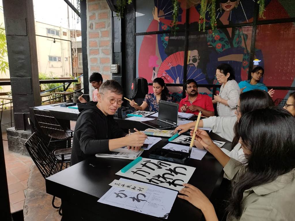 Geetha CT facilitating Japanese calligraphy classes. Photo credit: Geetha CT