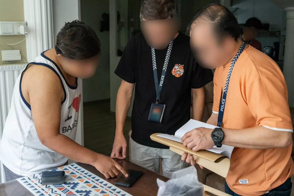 Singapore Police check a phone