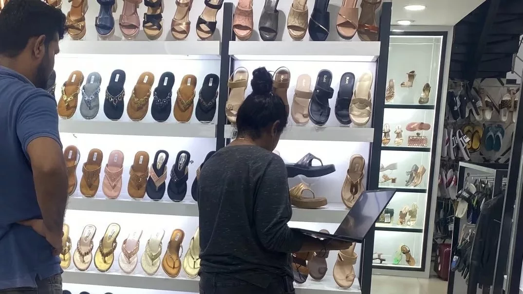 Woman attends office meeting on laptop while shopping for footwear in Bengaluru, photo goes viral