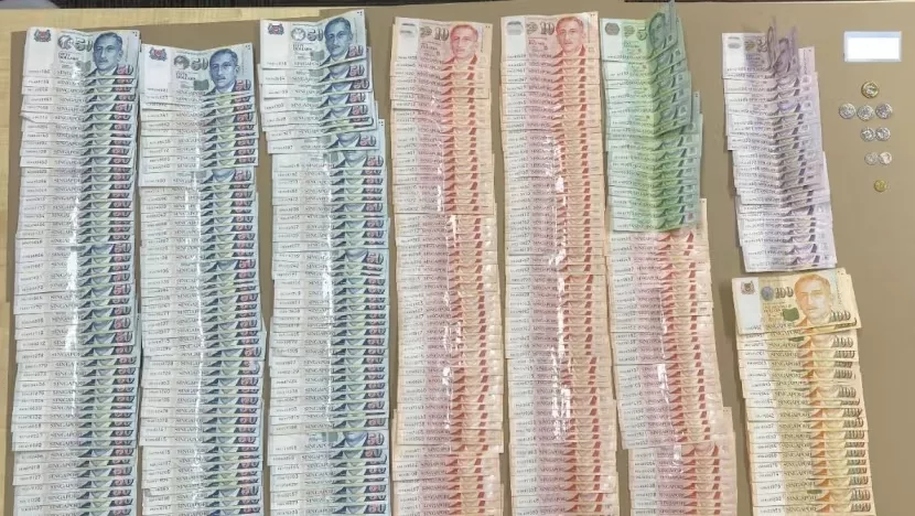 CNB officers seized cash during an operation conducted on November 20, 2023. Photo courtesy: CNB