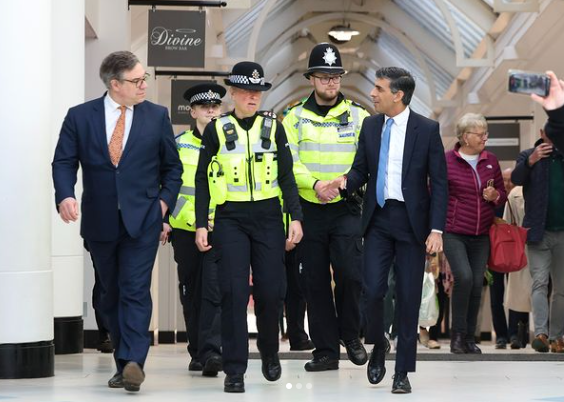 UK Prime Minister Rishi Sunak with police personnel