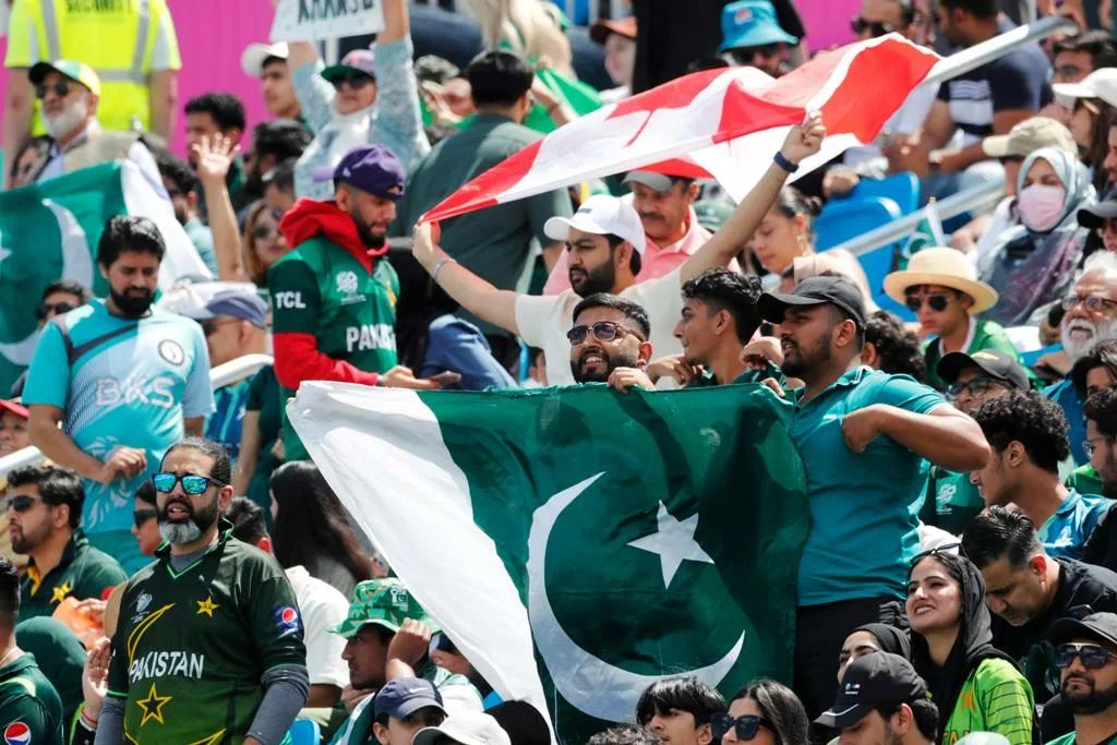 Fans of Pakistan cricket team waving the national flag during a game. Photo courtesy: x.com/ICC