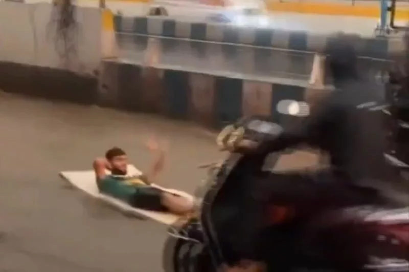 Pune man lying on his carpet to navigate streets of water-logged Pune