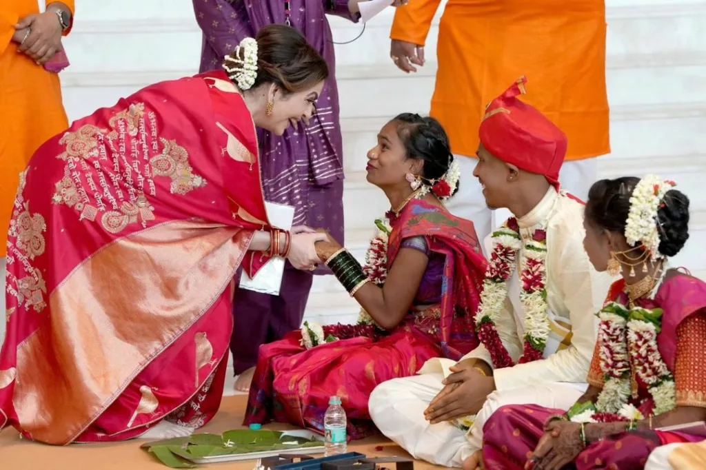 Neeta Ambani interacting with a couple. Photo courtesy: Collected