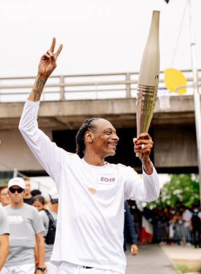 Rapper Snoop Dogg takes part in the torch relay at the Paris Olympics 2024 opening ceremony