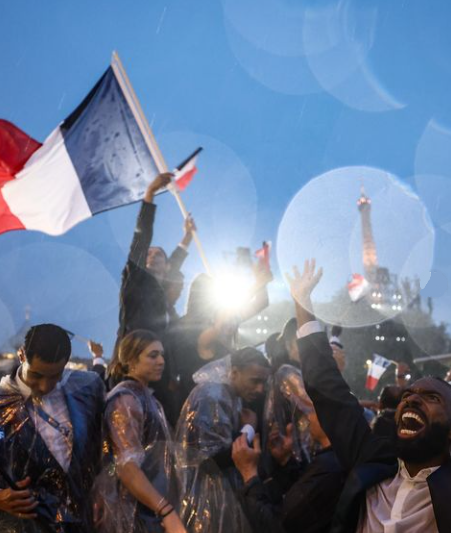 Paris Olympics 2024 opening ceremony spectators with the French national flag