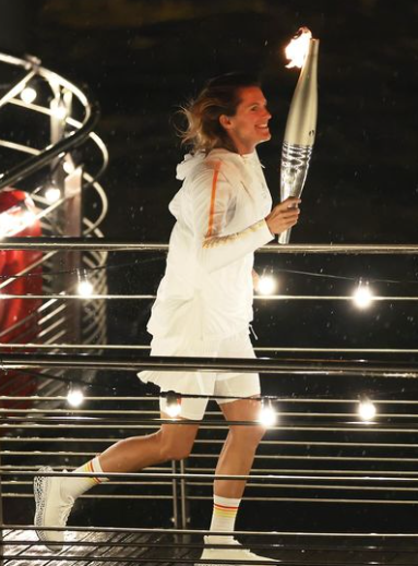 Amélie Mauresmo runs with the Paris Olympic torch