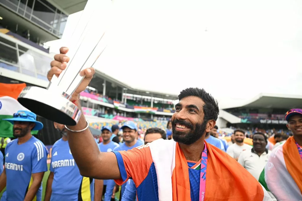 Jasprit Bumrah holds the ICC T20 World Cup trophy during India's victory lap at the Kensington Oval. Photo courtesy: ICC/X