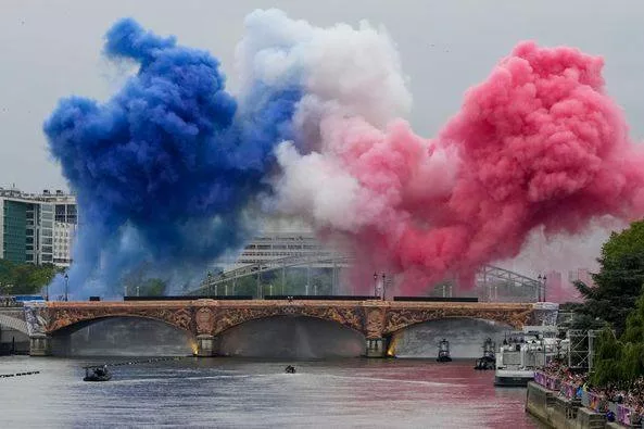 Colours of the French flag explode above the Seine at the Paris Olympics 2024 opening ceremony