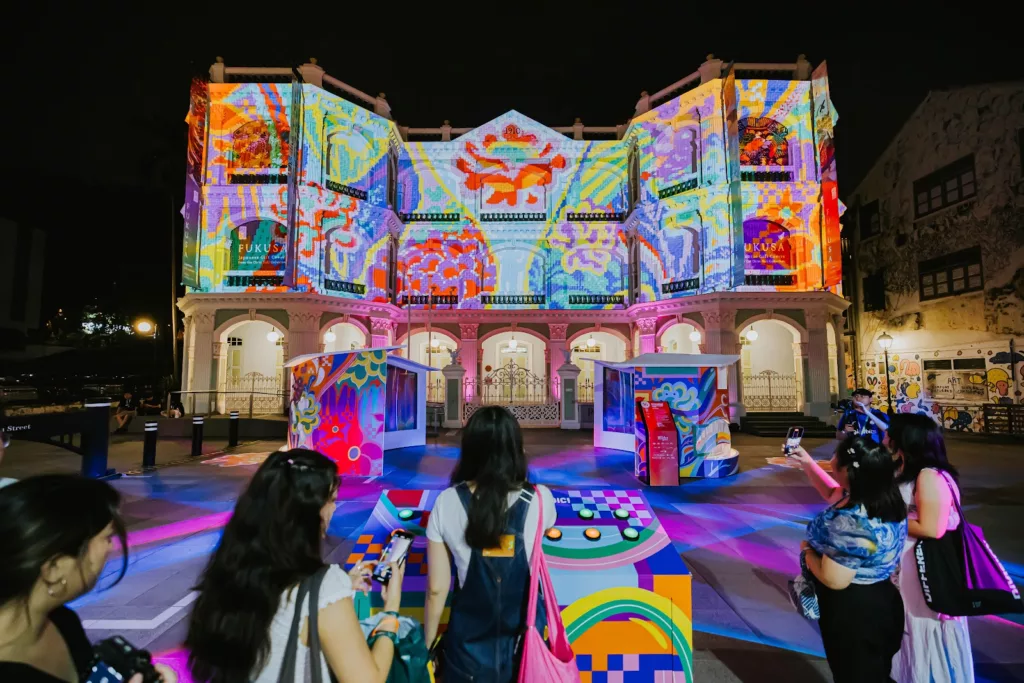 Festival-goers interacting with Between Threads at the Peranakan Museum