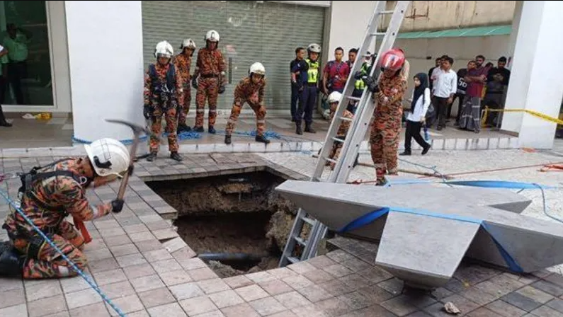 Indian woman falls into into pavement sinkhole in Malaysia, swept into sewer line