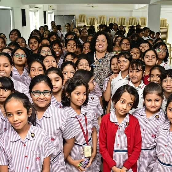 Savie Karnel with school students