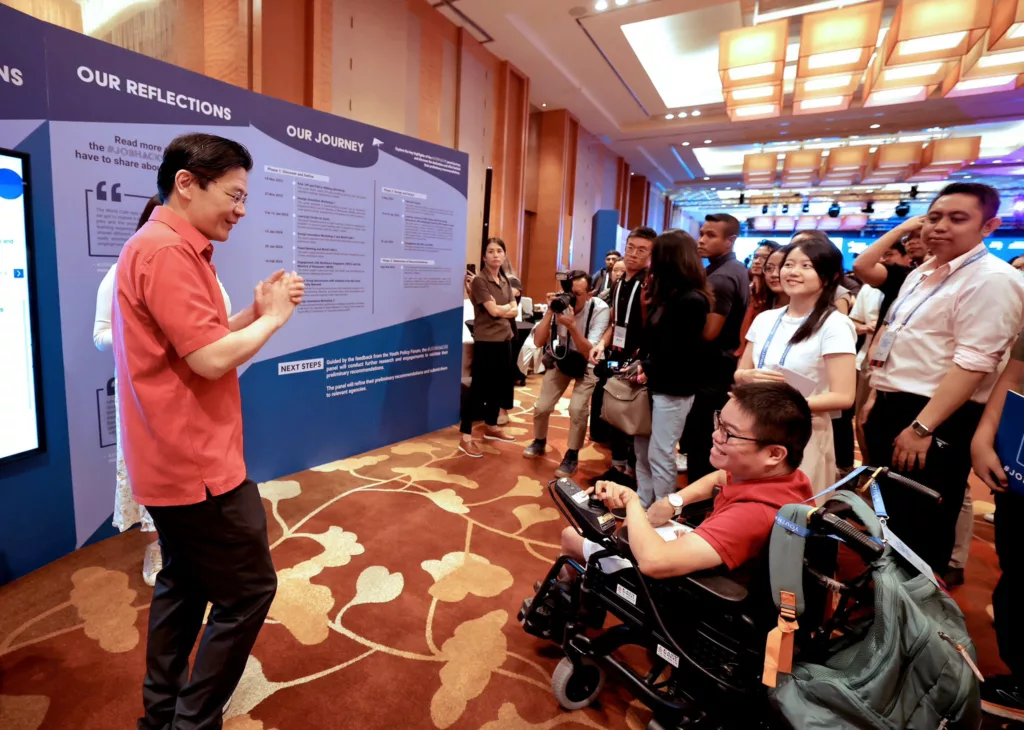 Singapore PM Lawrence Wong interacts with a differently-abled youth