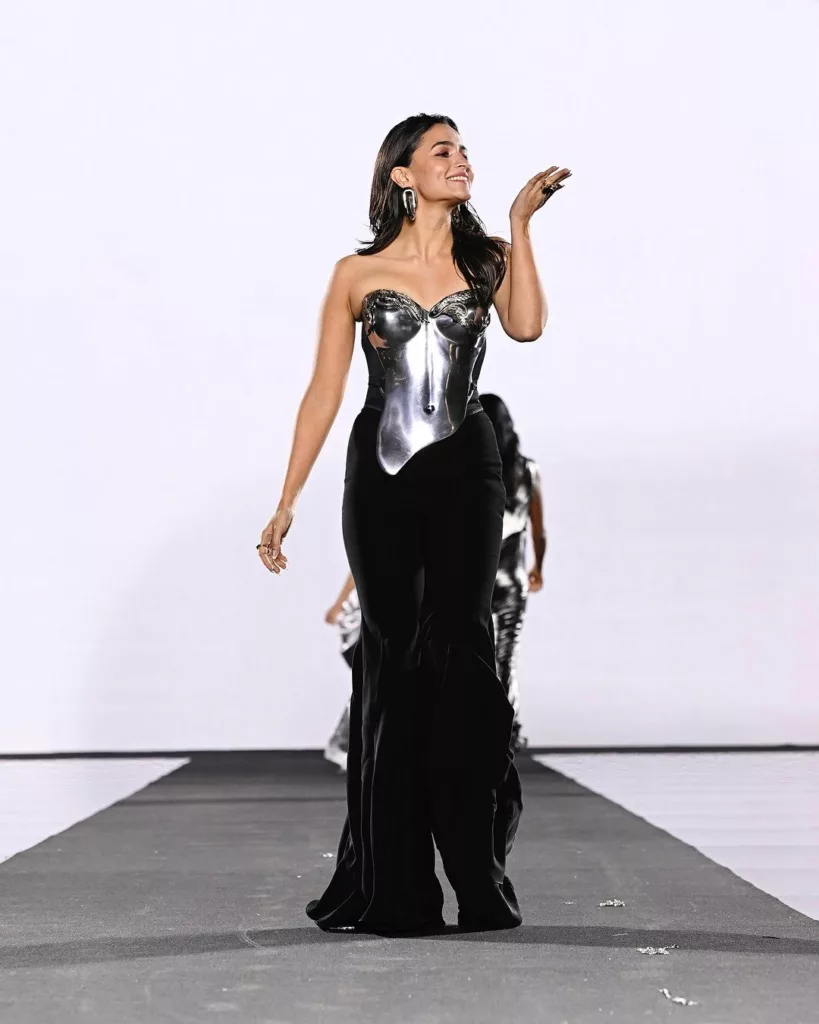 The 31-year-old actress wore a stunning black corset jumpsuit along with a metallic breastplate by Gaurav Gupta. Photo courtesy: www.instagram.com/aliaabhatt/