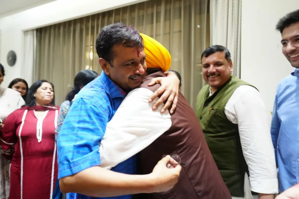 Arvind Kejriwal gets a hug from Bhagwant Mann