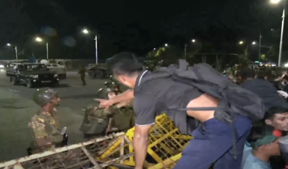 A protestor trying to climb a barricade during the agitation demanding the resignation of President Shahabuddin. Photo courtesy: Screengrab from YouTube.