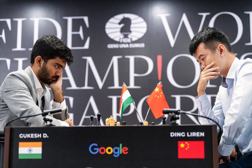 Ding Liren (right) won the first match of the 14-game championship against D Gukesh. Photo courtesy: Eng Chin An and Maria Emelianova via x.com/FIDE_chess