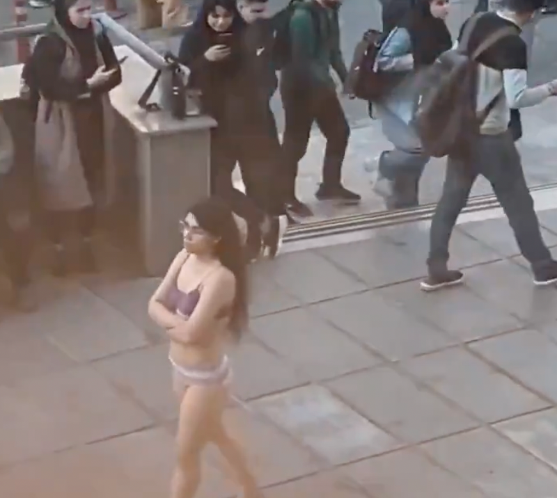 Iranian woman walks taking clothes off at university in Tehran to protest hijab mandate; detained