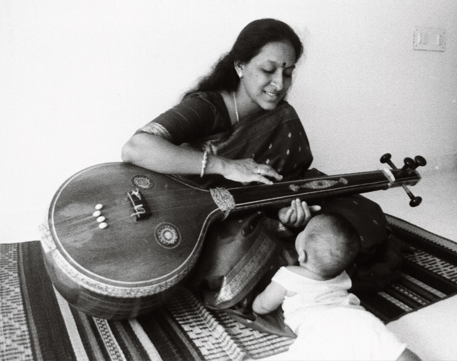 Amrit, then a toddler, plays as his mother, Bombay Jayashri, practices on the Veena. Photo courtesy: www.instagram.com/amritramnath