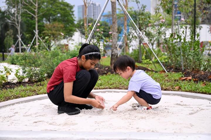 Children in the nature play area of Pek Kio Park