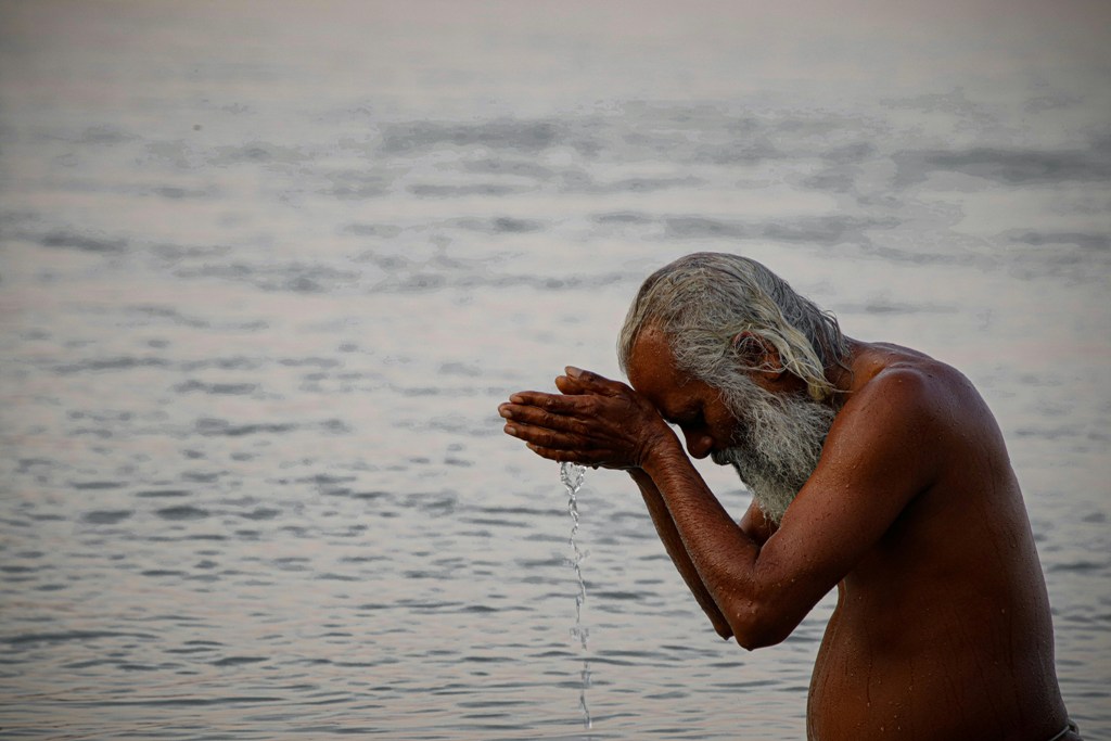 A man taking a dip in the Ganga. Representational image. Photo courtesy: Unsplash