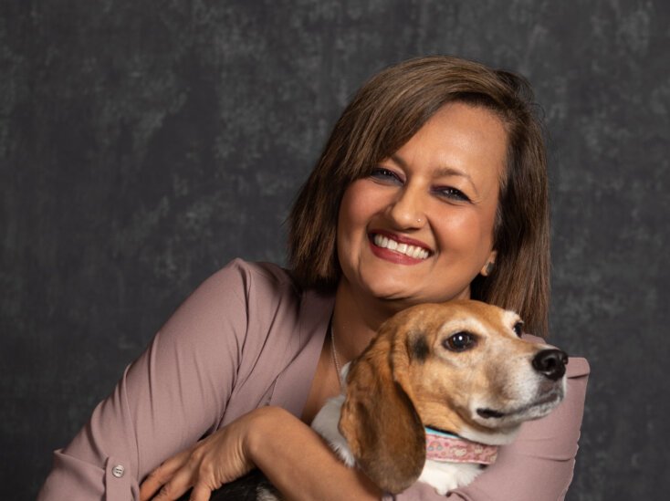 Poorva Joshipura posing with her dog.